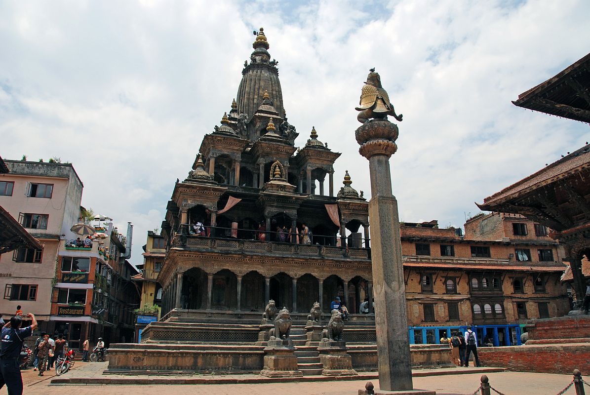 Kathmandu Patan Durbar Square 12 Krishna Mandir And Garuda Column Garuda kneels with folded arms on top of the column facing the Krishna Mandir in Patans Durbar Square. Krishna Mandir (1637) is an Indian style stone temple with a shikhara-style spire on top.